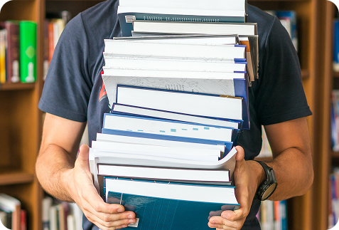 ScannX - Man holding many books CTA ScannX - Man holding many books CTA